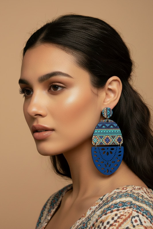 Blue earrings with geometric pattern on a beige background